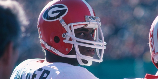 University of Georgia's running back Herschel Walker #34 looks over his shoulder from the sidelines during a game circa 1980-1982. Herschel Walker was elected to the College Football Hall of Fame in 1999.