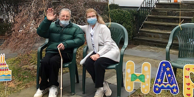 WWII veteran Stanley Tauber of New York (left) celebrated his 102nd birthday on Dec. 31, 2021 — and friends and community members came by to support him. He's shown above in the front yard of his home, with his daughter, Carol DeAngelis, on his birthday.