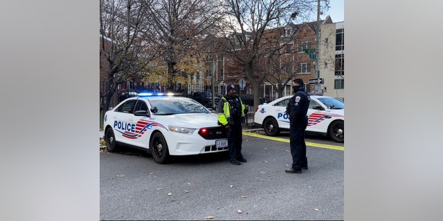 Metropolitan Police Department officers chatting by squad cars. (Fox News/Ethan Barton)