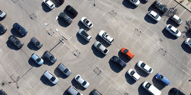 In this aerial photo, people in their cars are waiting to be tested for coronavirus at a drive-in test site on January 6, 2022 in Petah Tikva, Israel.  (Photo by Amir Levy / Getty Images)