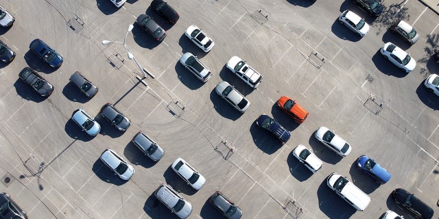 In this aerial view, people wait in their cars to be tested for coronavirus at a drive-in testing site on January 6, 2022 in Petah Tikva, Israel. (Photo by Amir Levy/Getty Images)