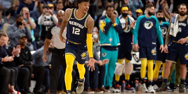 Memphis Grizzlies guard Ja Morant (12) reacts in the second half of an NBA basketball game against the Utah Jazz Friday, Jan. 28, 2022, in Memphis, Tenn.