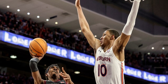 Oklahoma guard Marvin Johnson (5) puts up a shot as Auburn forward Jabari Smith (10) defends during the first half of an NCAA college basketball game Saturday, Jan. 29, 2022, in Auburn, Ala. Auburn beat Oklahoma 86-68.