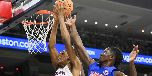 Auburn forward Jabari Smith (10) and Florida forward Anthony Duruji (4) battle for a rebound during the first half of an NCAA college basketball game Saturday, Jan. 8, 2022, in Auburn, Ala.