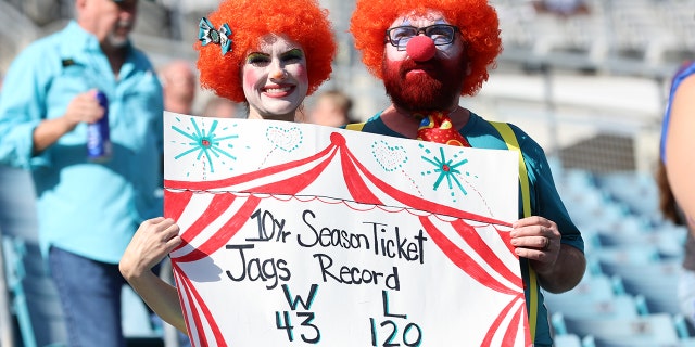 Fans in the stands hold up a sign before the game between the Indianapolis Colts and the Jacksonville Jaguars at TIAA Bank Field on January 9, 2022 in Jacksonville, Florida.