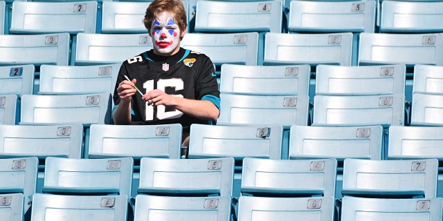 A Jacksonville Jaguars fan painted as a clown in the stands before the Indianapolis Colts vs Jags game at TIAA Bank Field on January 9, 2022, in Jacksonville, Florida.