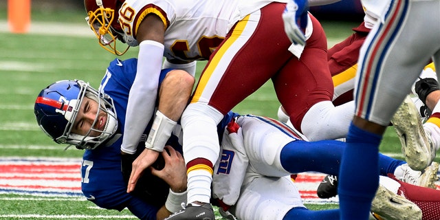 New York Giants quarterback Jake Fromm (17) is sacked by Washington Football Team cornerback Danny Johnson during the first quarter Saturday, Jan. 9, 2021, in East Rutherford, N.J.