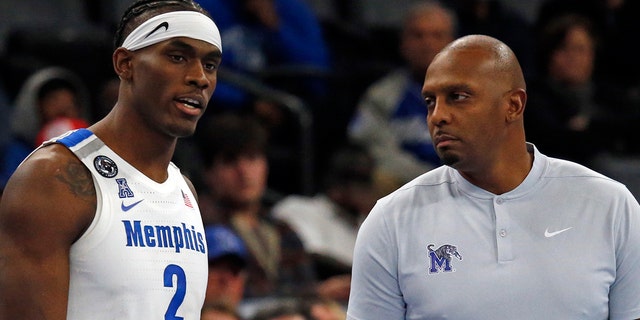 Jan 20, 2022; Memphis, Tennessee, USA; Memphis Tigers center Jalen Duren (2) talks with head coach Penny Hardaway (right) as he waits to check in during the second half against the Southern Methodist Mustangs at FedExForum.