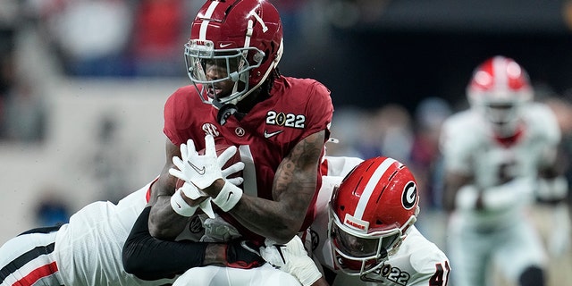 Alabama's Jameson Williams is stopped during the first half of the College Football Playoff championship football game against Georgia Monday, Jan. 10, 2022, in Indianapolis.