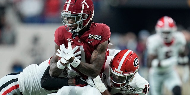 Alabama's Jameson Williams is stopped during the first half of the College Football Playoff championship football game against Georgia Monday, Jan. 10, 2022, in Indianapolis.