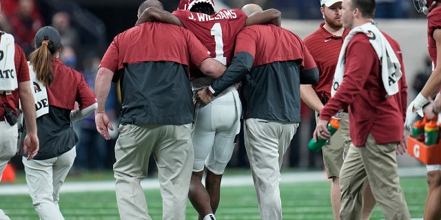 Alabama's Jameson Williams injures his knee after a catch during the first half of the College Football Playoff championship football game against Georgia Monday, Jan. 10, 2022, in Indianapolis.