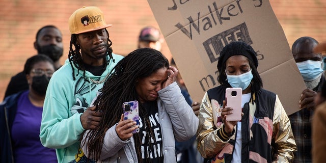 Demonstrators get emotional during a Justice for Jason Walker demonstration in front of the Fayetteville Police Dept. on Sunday, Jan. 9, 2022.