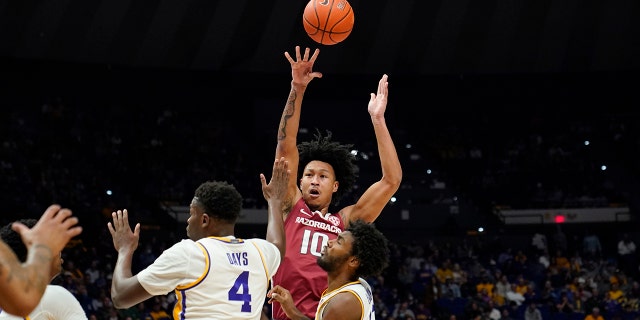 Arkansas forward Jaylin Williams (10) shoots over LSU forward Darius Days (4) in the first half of an NCAA college basketball game in Baton Rouge, La., Saturday, Jan. 15, 2022.