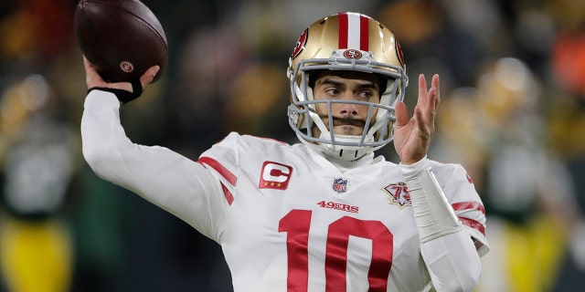 San Francisco 49ers' Jimmy Garoppolo warms up before the NFC divisional playoff game against the Green Bay Packers on Jan. 22, 2022, in Green Bay, Wisconsin.