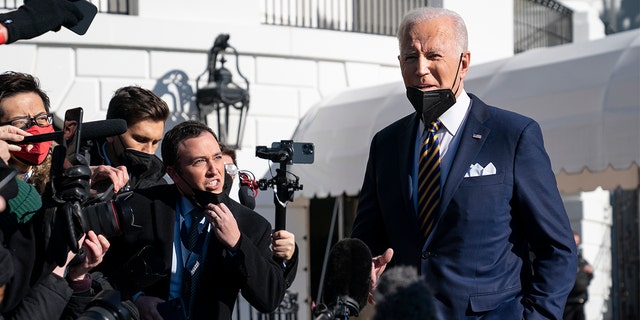 President Biden talks to reporters before boarding Marine One on the South Lawn of the White House, Tuesday, Jan. 11, 2022, in Washington. 