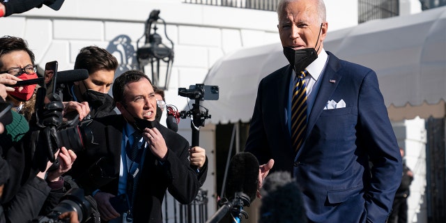 President Biden talks to reporters before boarding Marine One on the South Lawn of the White House, Tuesday, Jan. 11, 2022, in Washington.
