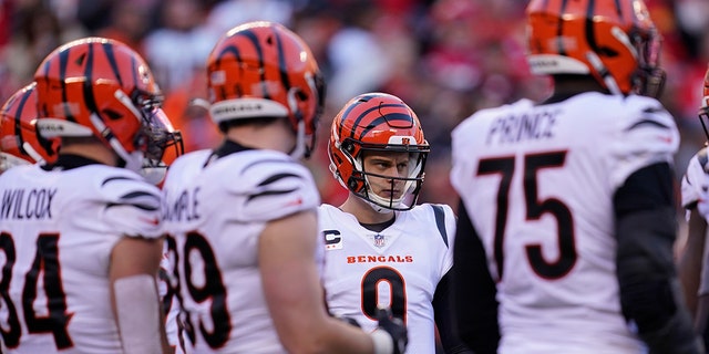 Cincinnati Bengals quarterback Joe Burrow (9) calls a play in the huddle during the second half of the AFC championship NFL football game against the Kansas City Chiefs, Sunday, Jan. 30, 2022, in Kansas City, Mo.