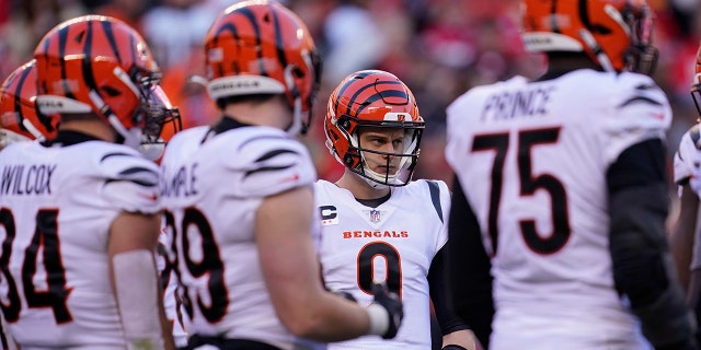 Cincinnati Bengals quarterback Joe Burrow (9) calls a play in the huddle during the second half of the AFC championship NFL football game against the Kansas City Chiefs, Sunday, Jan. 30, 2022, in Kansas City, Mo.