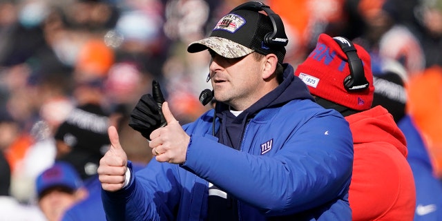 New York Giants head coach Joe Judge signals his team during the first half of an NFL football game against the Chicago Bears Sunday, Jan. 2, 2022, in Chicago.