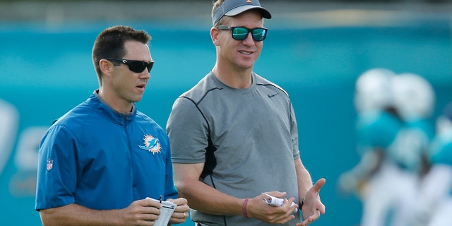 Joe Schoen, Director of Player Personnel and Peyton Manning, former NFL quarterback watches the Miami Dolphins run drills during the teams training camp on August 1, 2016 at the Miami Dolphins training facility in Davie, Florida.