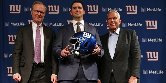 New York Giants new head coach Joe Judge, center, poses for photographs with team CEO John Mara, left, chairman and executive vice president Steve Tisch, right, after a news conference at MetLife Stadium on Jan. 9, 2020, in East Rutherford, New Jersey.