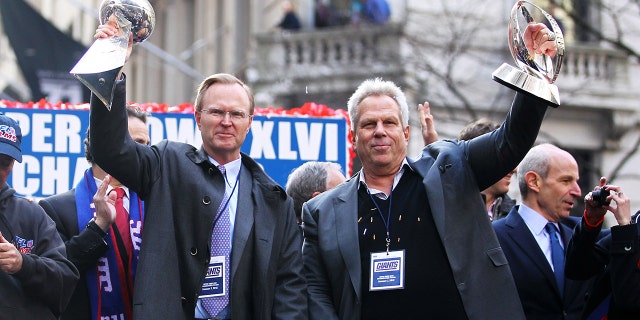 New York Giant co-owners John Mara (L) and Steve Tisch celebrate during the Giants' ticker tape victory parade down the Canyon of Heroes on Feb. 7, 2012, in New York City.