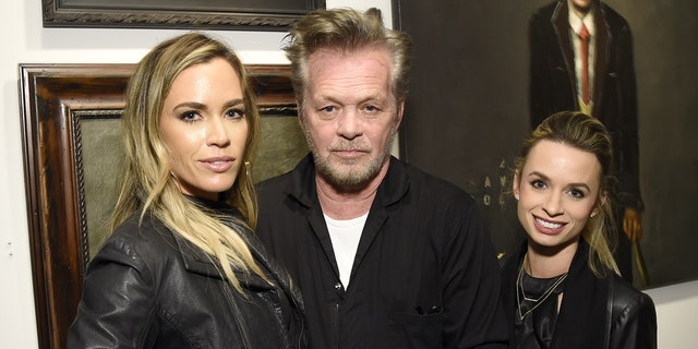 Teddi Jo Mellencamp, left, is seen with musician father, John Mellencamp and sister Justice Mellencamp. The rocker said he hasn't had any ‘girls’ or ‘hangers-on’ backstage at any of hs shows since his ex-wife, Elaine Irwin, banned them back in 1991.