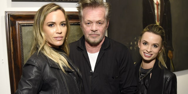 Teddi Jo Mellencamp, left, is seen with musician father, John Mellencamp and sister Justice Mellencamp. The rocker said he hasn't had any ‘girls’ or ‘hangers-on’ backstage at any of hs shows since his ex-wife, Elaine Irwin, banned them back in 1991.