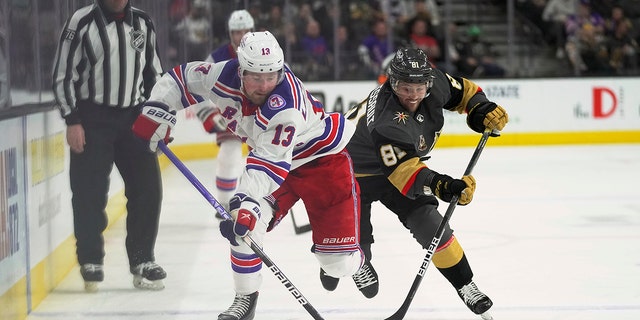 New York Rangers left wing Alexis Lafrenière (13) and Vegas Golden Knights center Jonathan Marchessault (81) compete for the puck during the third period of an NHL hockey game Thursday, Jan. 6, 2022, a Las Vegas. The Golden Knights won 5-1.