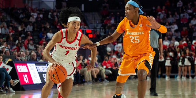 Georgia guard Chloe Chapman (1) drives past Tennessee guard Jordan Horston (25) during the second half of an NCAA college basketball game Sunday, Jan.. 23, 2022, in Athene, Ga.