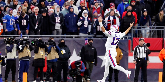 Buffalo Bills quarterback Josh Allen celebrates in front of fans in Foxborough, Mass., after a touchdown by tight end Dawson Knox during the second half of a game Dec. 26, 2021.