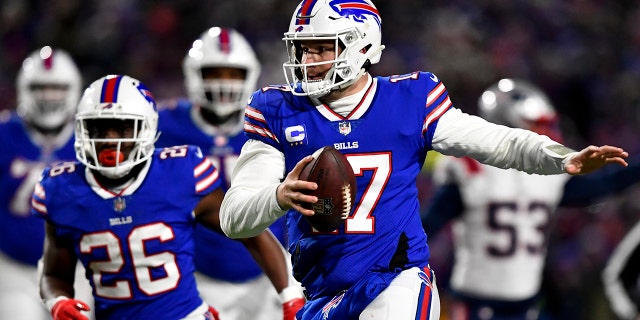 Buffalo Bills quarterback Josh Allen (17) runs the ball during the first half of an NFL wild-card playoff football game against the New England Patriots, Saturday, Jan. 15, 2022, in Orchard Park, N.Y.