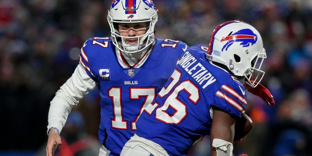 Buffalo Bills quarterback Josh Allen (17) hands the ball off to running back Devin Singletary (26) during the first half of an NFL wild-card playoff football game against the New England Patriots, Saturday, Jan. 15, 2022, in Orchard Park, N.Y.