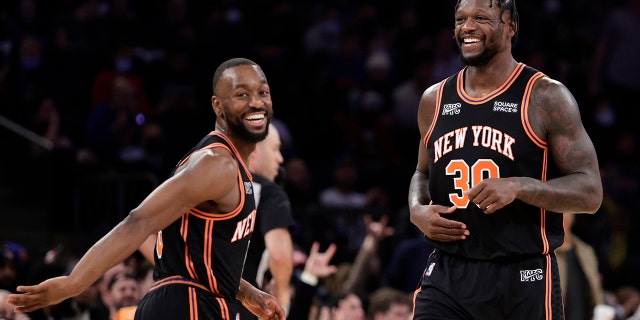 New York Knicks forward Julius Randle (30) and Kemba Walker react during the second half of an NBA basketball game against the Atlanta Hawks on Saturday, Dec. 25, 2021, in New York. The Knicks won 101-87.
