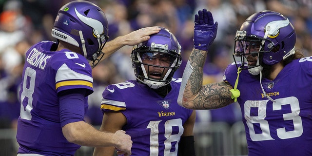 Vikings quarterback Kirk Cousins congratulates wide receiver Justin Jefferson after they teamed up for a touchdown against the Chicago Bears, Jan. 9, 2022, at U.S. Bank Stadium in Minneapolis.