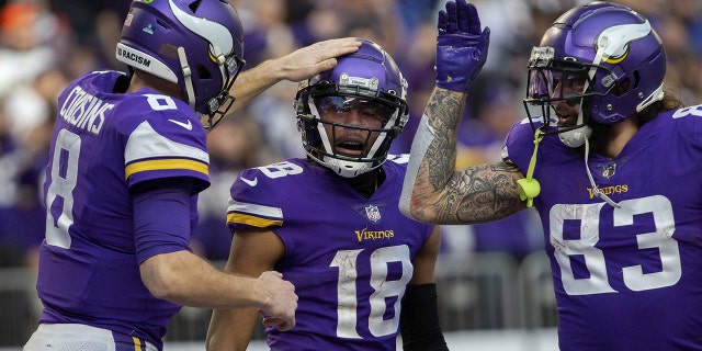 Vikings quarterback Kirk Cousins congratulates wide receiver Justin Jefferson after they teamed up for a touchdown against the Chicago Bears, Jan. 9, 2022, at U.S. Bank Stadium in Minneapolis.