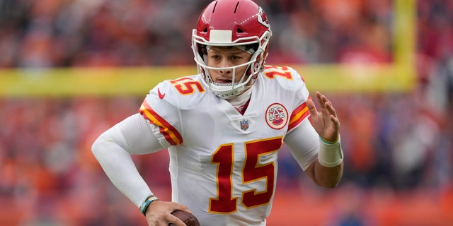 Kansas City Chiefs quarterback Patrick Mahomes (15) scrambles against the Denver Broncos during the first half of an NFL football game Saturday, Jan. 8, 2022, in Denver. 