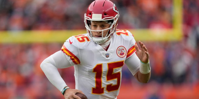 Kansas City Chiefs quarterback Patrick Mahomes (15) scrambles against the Denver Broncos during the first half of an NFL football game Saturday, Jan. 8, 2022, in Denver. (AP Photo/David Zalubowski)