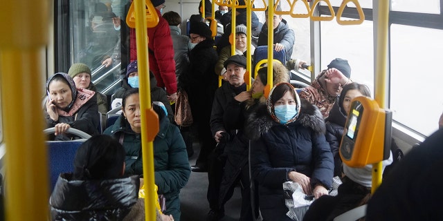 People ride a municipal bus in Almaty, Kazakhstan, Monday, Jan. 10, 2022.