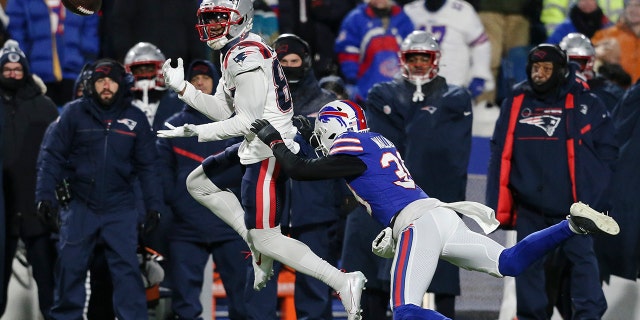 New England Patriots wide receiver Kendrick Bourne (84) strikes a blow against Buffalo Bill's cornerback Levi Wallace (39) during the first half of an NFL wild-card playoff football game Saturday, January 15, 2022 in Orchard Park, NY