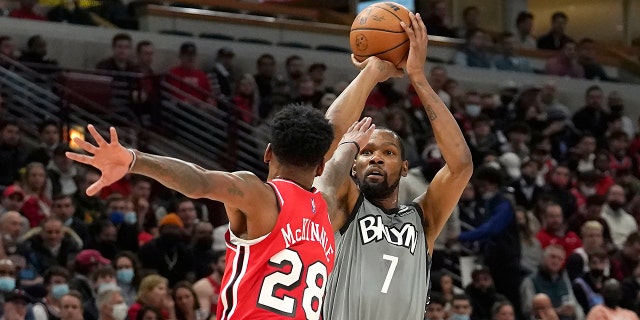 Brooklyn Nets' Kevin Durant shoots over Chicago Bulls' Alfonzo McKinnie during the first half of an NBA basketball game Wednesday, Jan. 12, 2022, in Chicago.