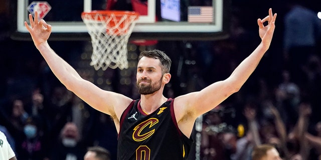 Cleveland Cavaliers' Kevin Love (0) reacts after hitting a 3-point shot in the first half of an NBA basketball game against the Milwaukee Bucks, Wednesday, Jan. 26, 2022, in Cleveland.