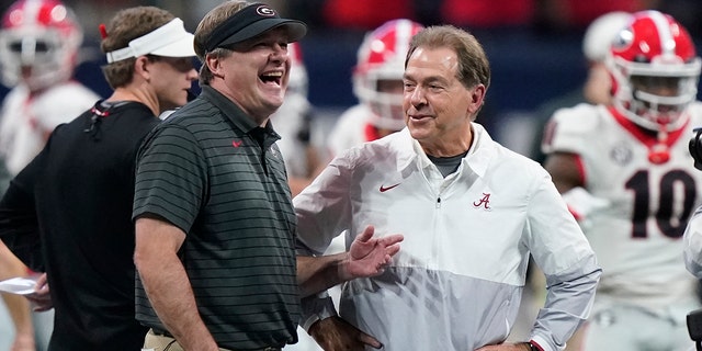 FILE - Georgia head coach Kirby Smart speaks with Alabama head coach Nick Saban before the first half of the Southeastern Conference championship NCAA college football game, Saturday, Dec. 4, 2021, in Atlanta. Georgia plays Alabama in the College Football Playoff national championship game on Jan. 10, 2022. 