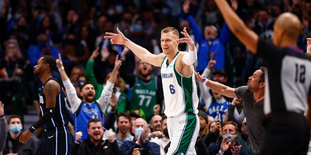 Dallas Mavericks forward Kristaps Porzingis (6) celebrates a three-point basket at the buzzer at the end of the first quarter of an NBA basketball game against the Orlando Magic, Saturday, Jan. 15, 2022, in Dallas.