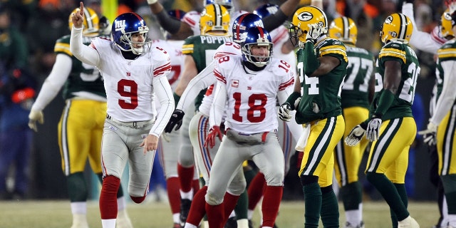 Kicker Lawrence Tynes #9 of the New York Giants celebrates after kicking the game winning 47-yard field goal to win the NFC championship game against the Green Bay Packers on Jan. 20, 2008 at Lambeau Field in Green Bay, Wisconsin. The Giants defeated the Packers 23-20 in overtime to advance to the Superbowl XLII.