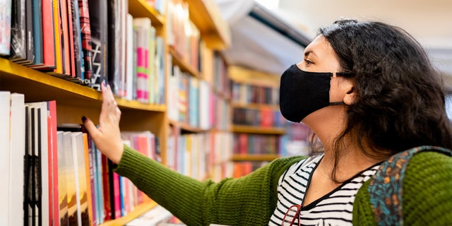 masked person in library