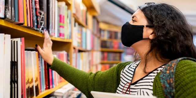 masked person in library