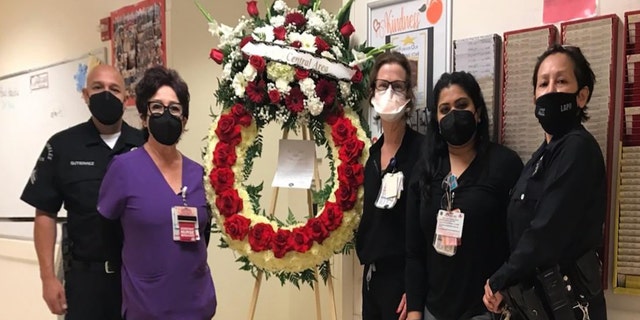Members of the LAPD are seen delivered a floral arrangement to Los Angeles County-USC Medical Center staff in memory of Sandra Shells, according to LAPD Captain Elaine Morales.