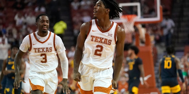 Texas guard Marcus Carr (2) celebrates with teammate Courtney Ramey (3) after making a basket at the end of the first half of an NCAA college basketball game against West Virginia, Saturday, Jan. 1, 2022, in Austin, Texas.