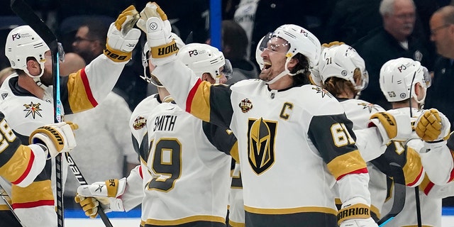 Vegas Golden Knights right wing Mark Stone (61) celebrates with teammates after scoring the game-winning goal during a shoot out against the Tampa Bay Lightning during an NHL hockey game Saturday, Jan. 29, 2022, in Tampa, Fla.